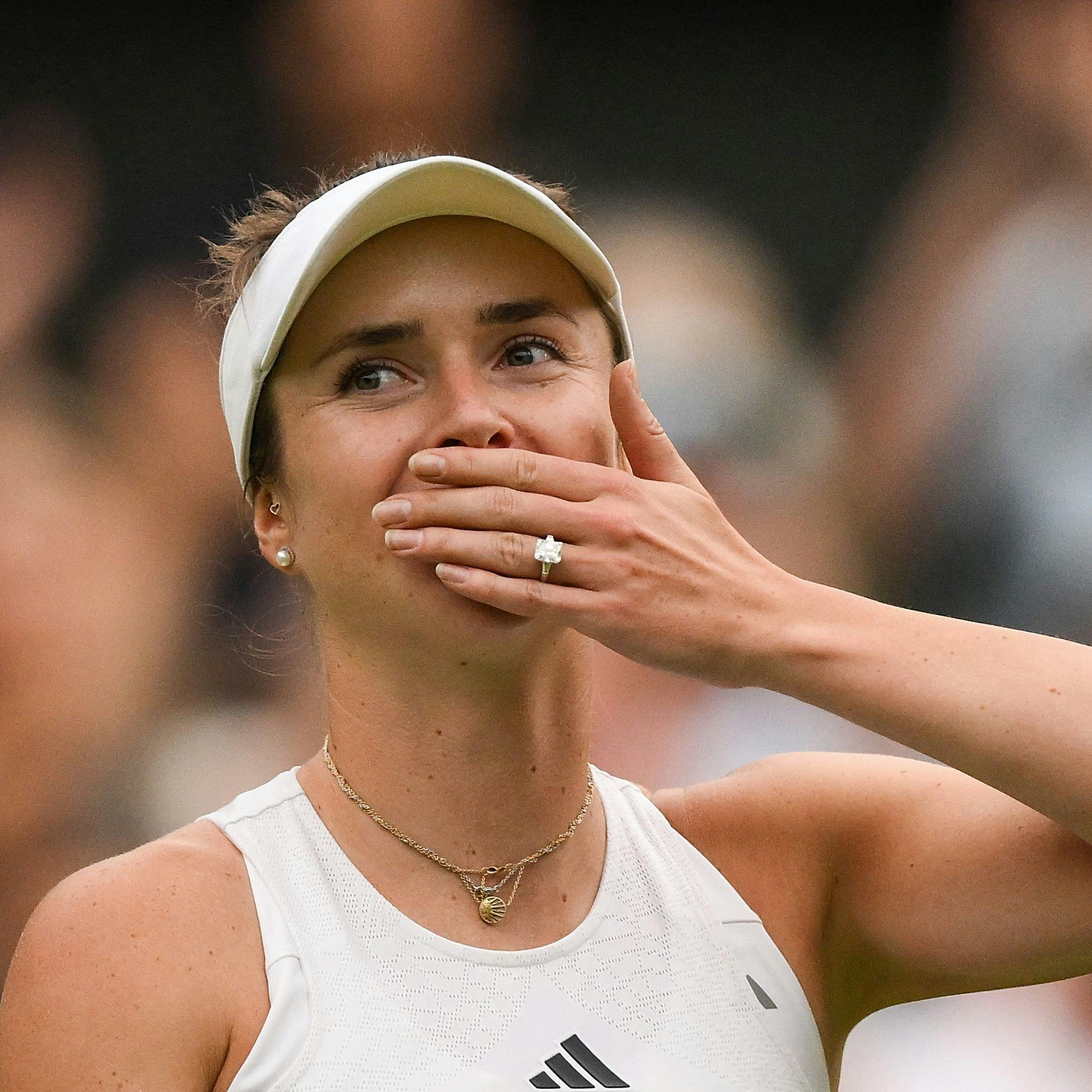 TOPSHOT - Ukraine's Elina Svitolina blows a kiss as she celebrates winning against Poland's Iga Swiatek during their women's singles quarter-finals tennis match on the ninth day of the 2023 Wimbledon Championships at The All England Tennis Club in Wimbledon, southwest London, on July 11, 2023. (Photo by Daniel LEAL / AFP) / RESTRICTED TO EDITORIAL USE
