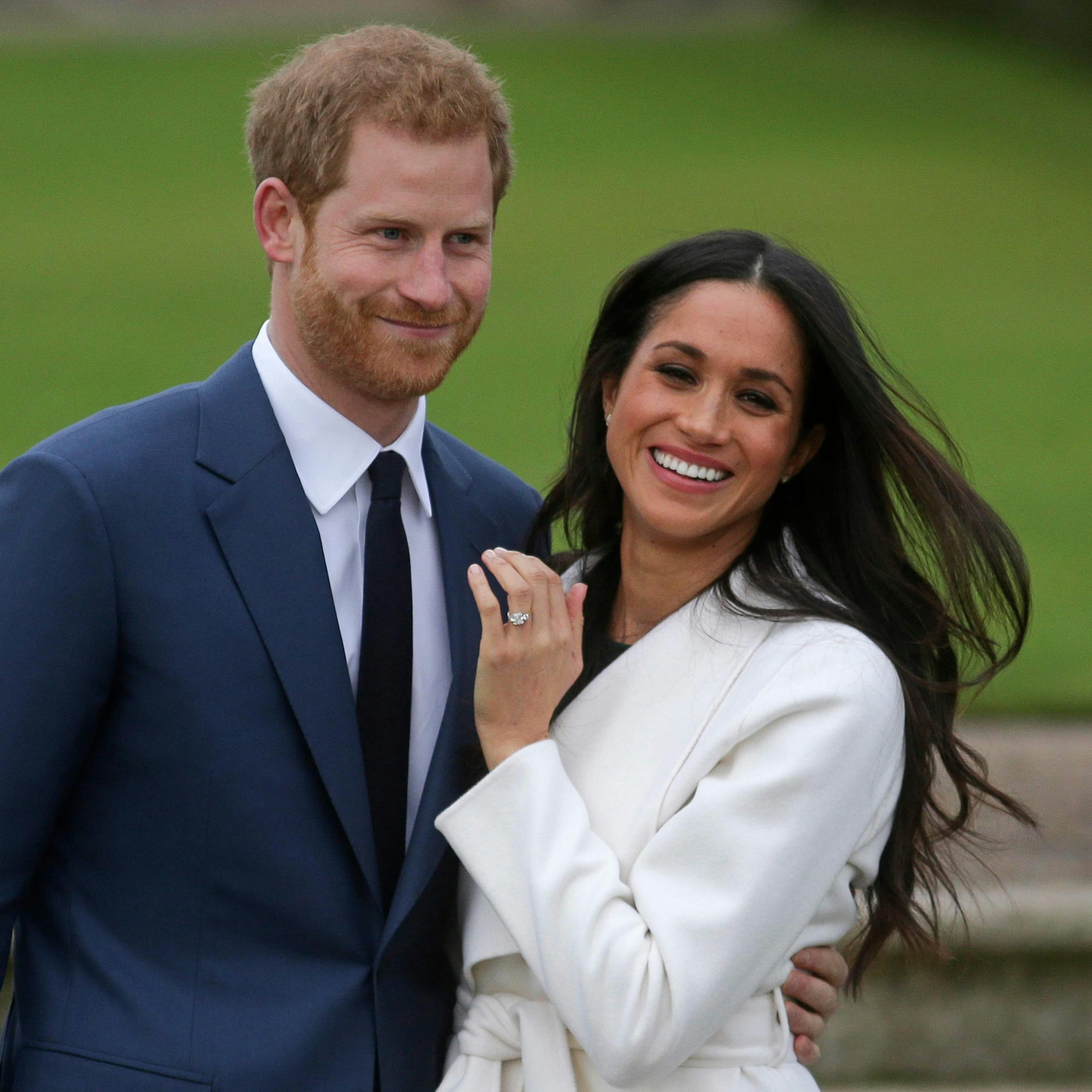Prince Harry stands with his fiancée US actress Meghan Markle