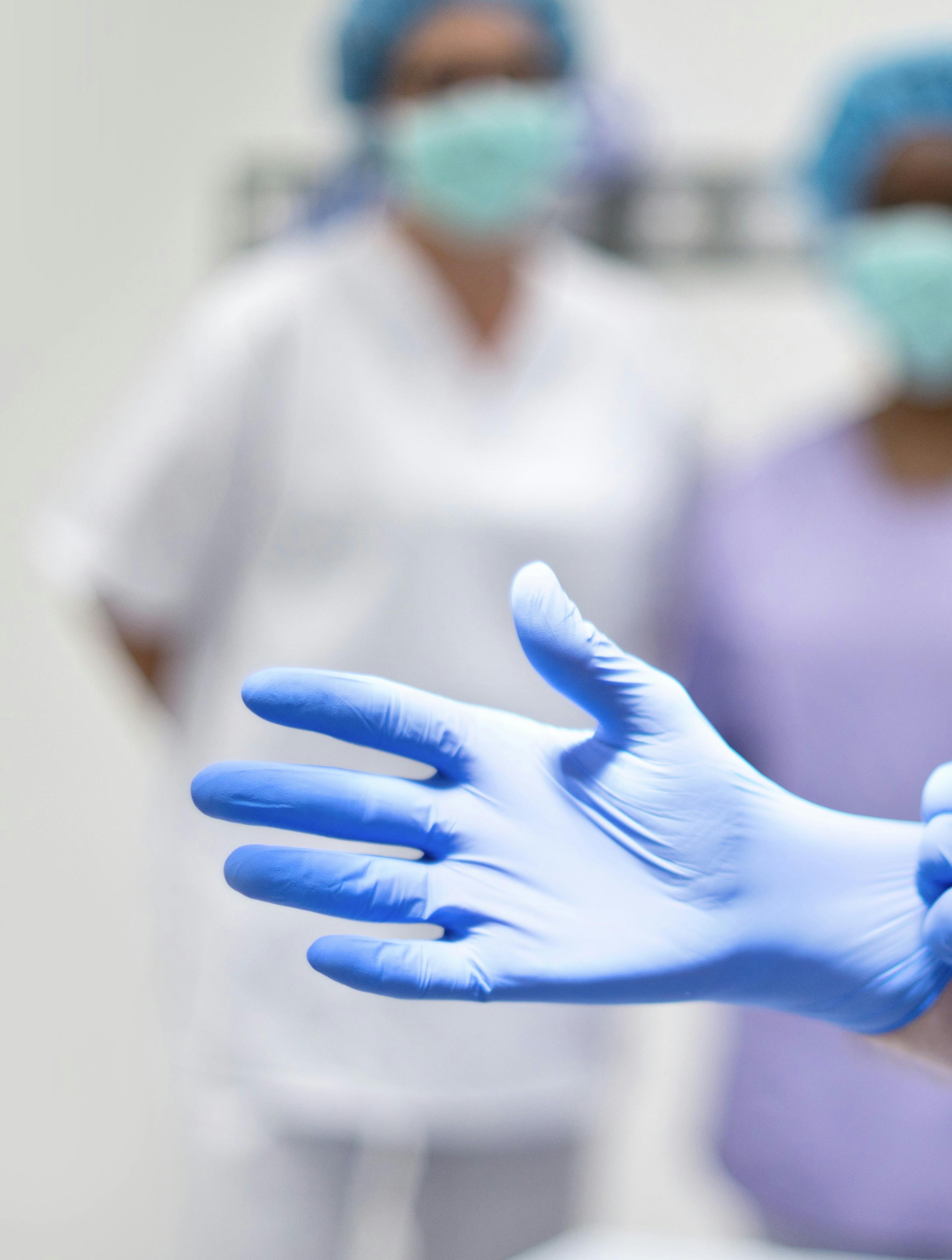  Surgeon putting on latex glove
